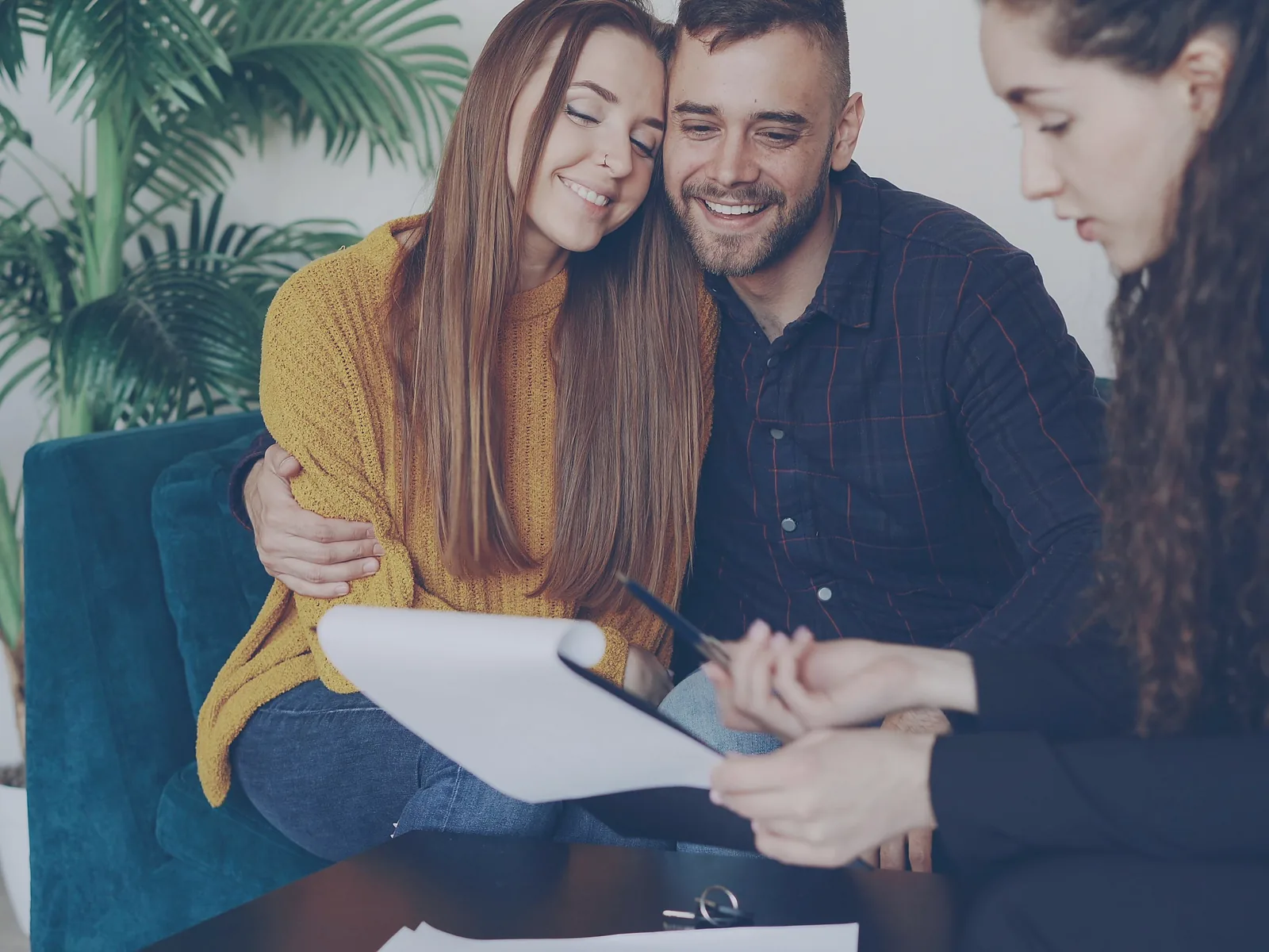 Advisor listening while a couple reviews financial planning documents